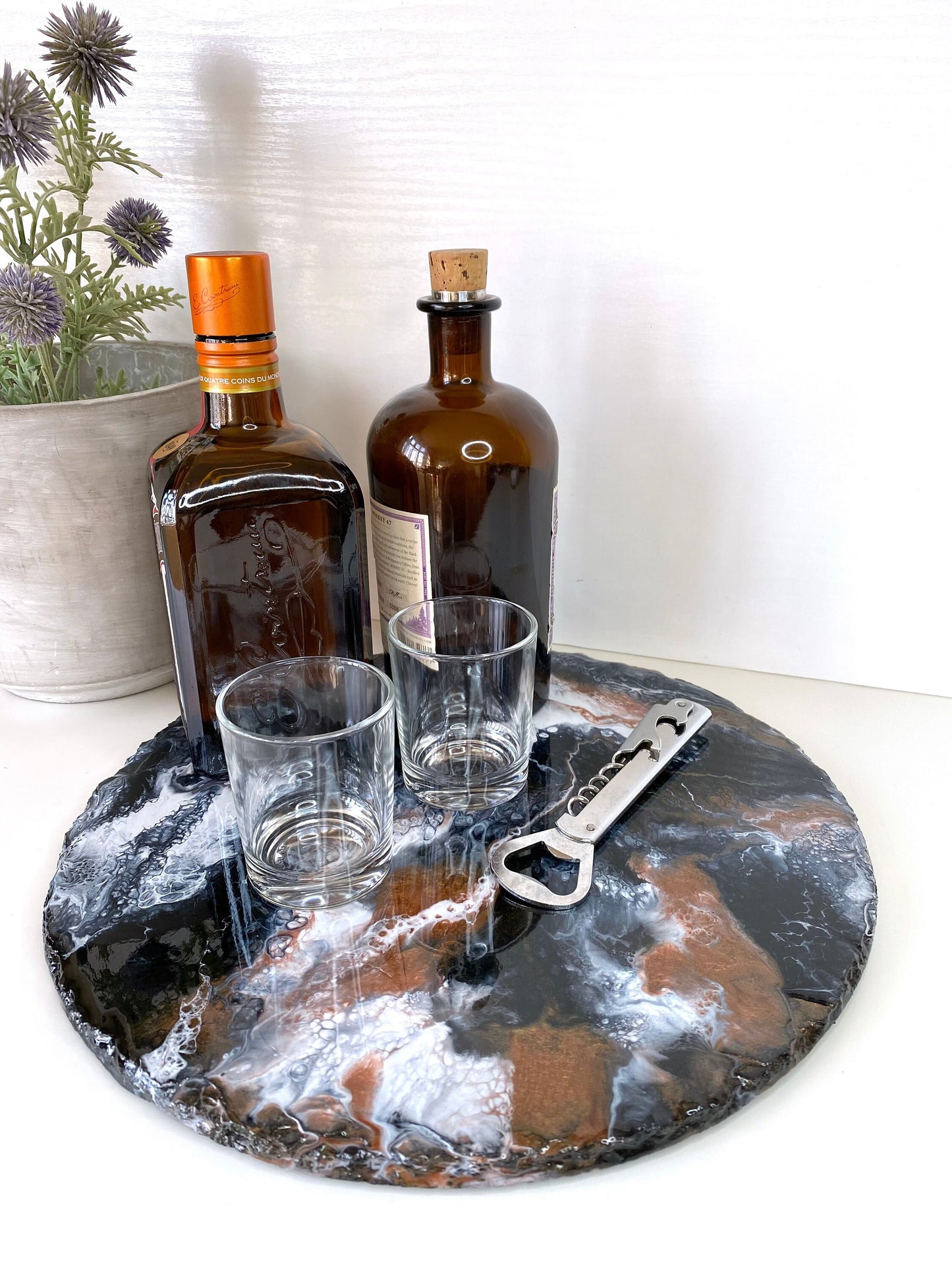 Handmade black and bronze resin tray with slate base, large round coffee table and vanity tray, styled as a bar with alcohol bottles, wine opener and two small glasses, elegant decorative tray for home display or entertaining