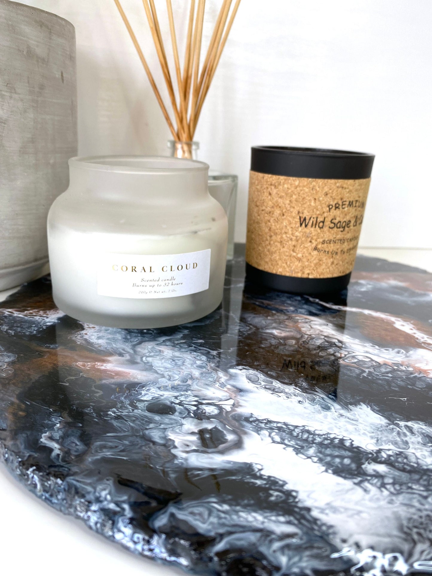 Close-up of handmade black and bronze resin tray with slate base, large round coffee table and vanity tray, styled with candles and diffuser, highlighting resin details and elegant home décor.