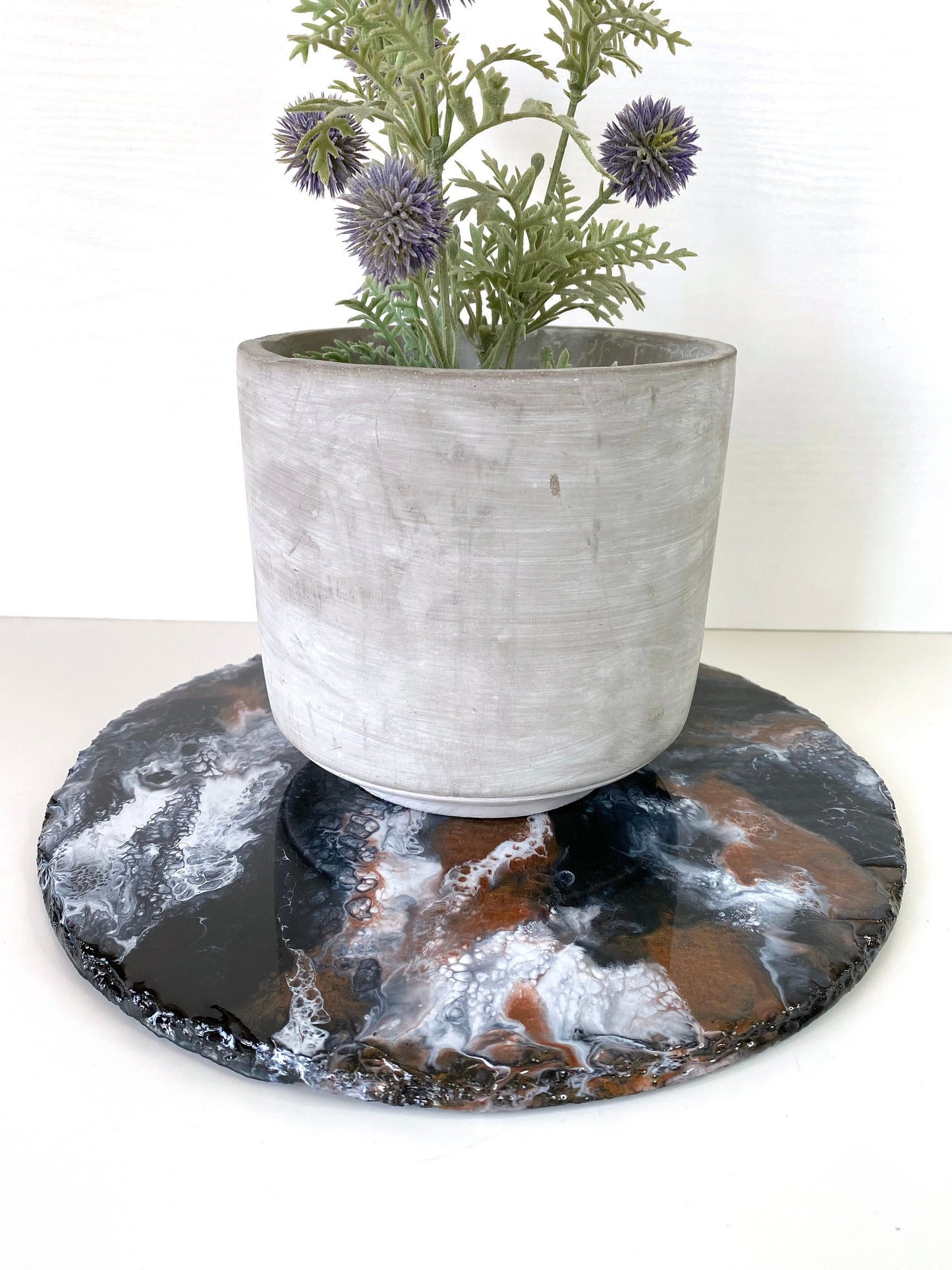 Handmade black and bronze resin tray with slate base, large round coffee table and vanity tray, styled with decorative pot on tray, showcasing elegant home décor and resin craftsmanship.