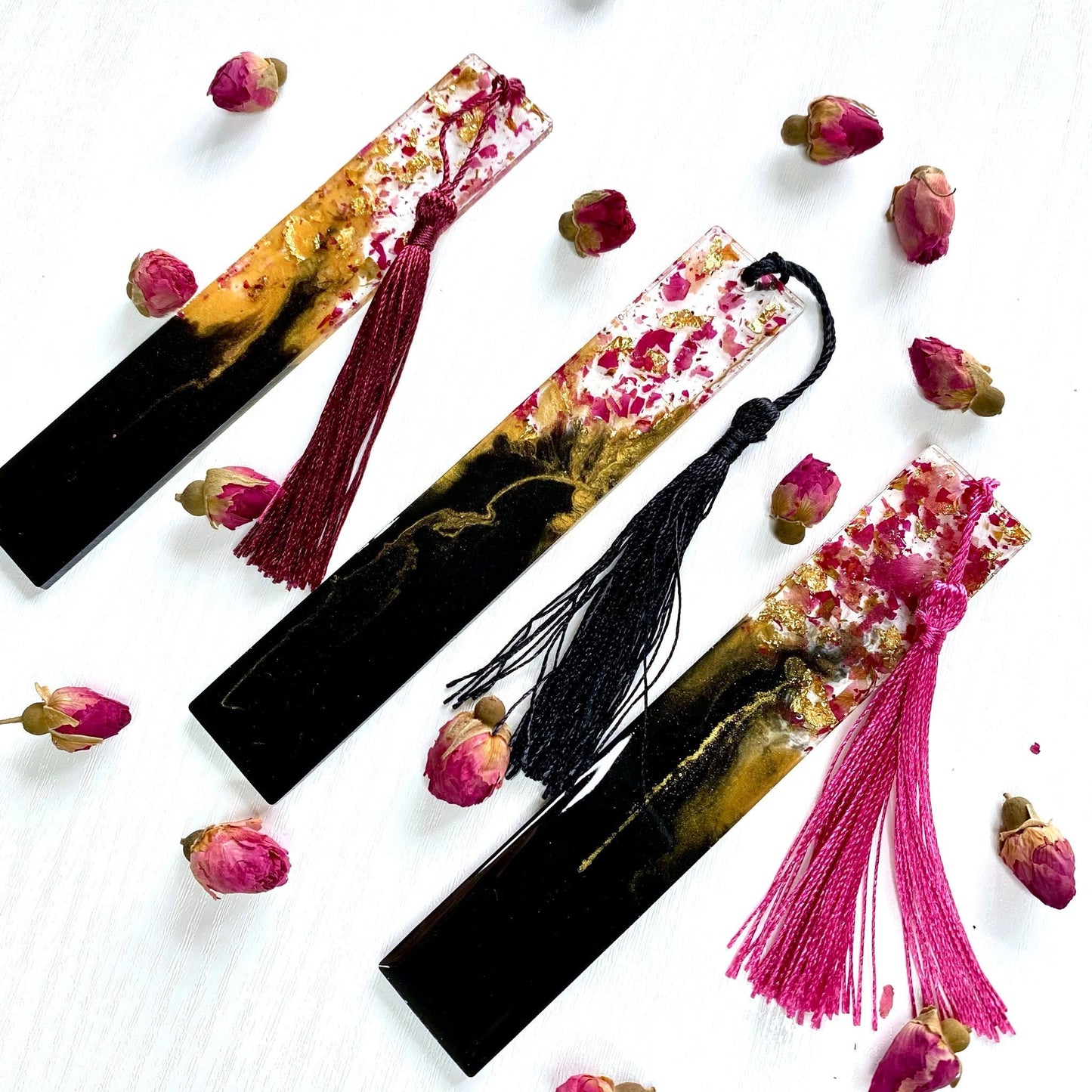 Black and gold resin bookmark with dried rose petals in clear resin top and matching colourful tassel attached