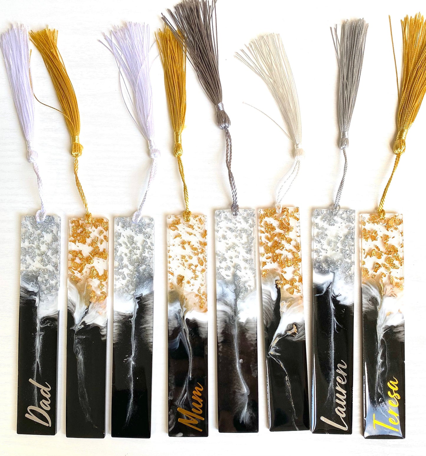 Collection of black and white resin bookmarks with gold and silver leaf, showing all designs and personalised and non-personalised options, elegant handmade bookmarks for readers or gifts.