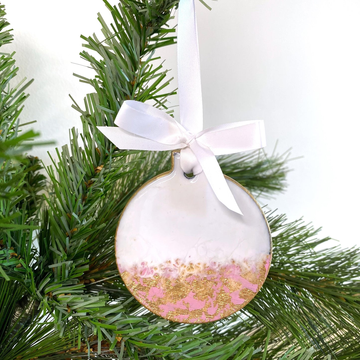 Close-up of pink slate resin Baby’s First Christmas ornament, non-personalised, showing smooth resin finish, hand-painted gold edges, and white ribbon for hanging.