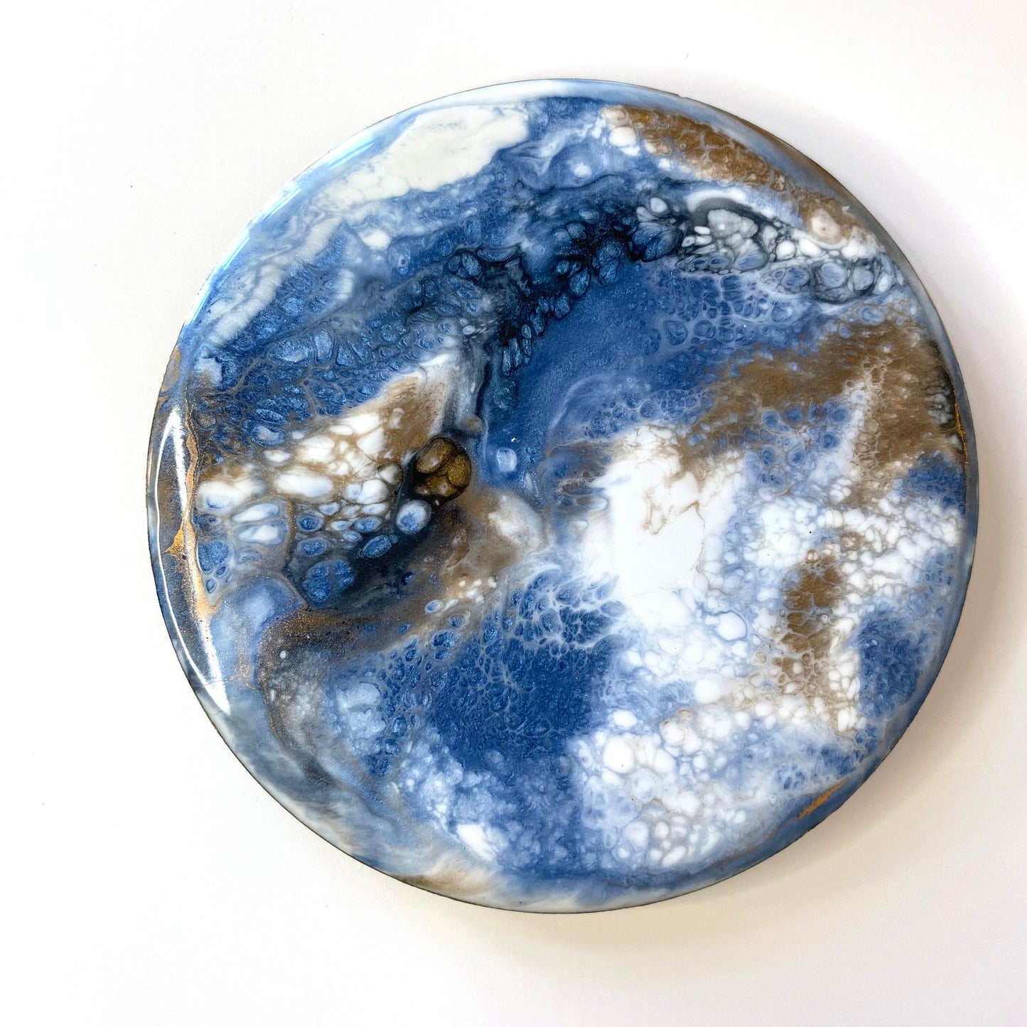 Handmade round slate resin coaster with unique blue, white, black, and gold epoxy design – each piece is individually crafted and unique