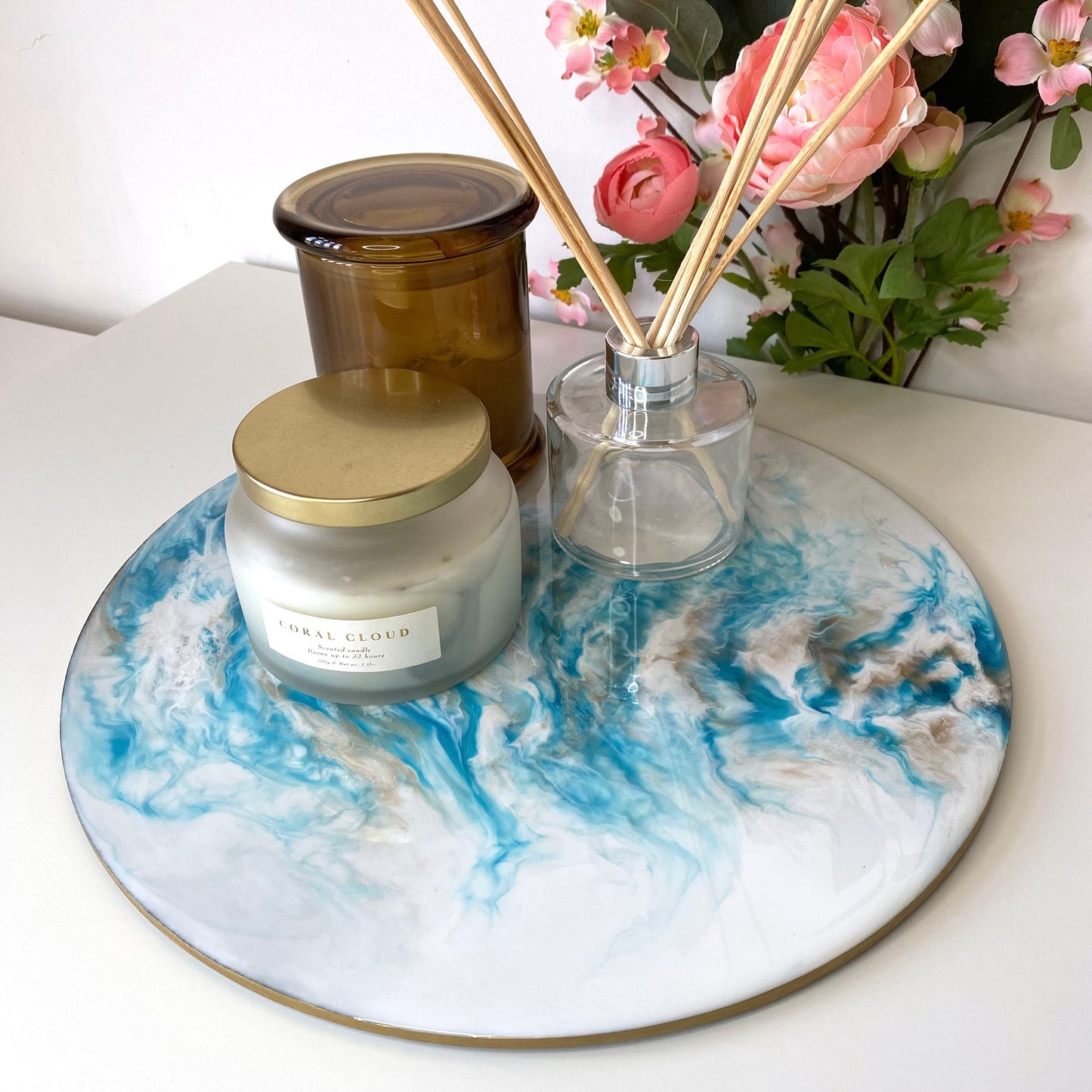 Handmade white and blue resin tray with slate base, large round coffee table and decorative tray, styled with candles and diffuser, elegant home display for serving or décor.