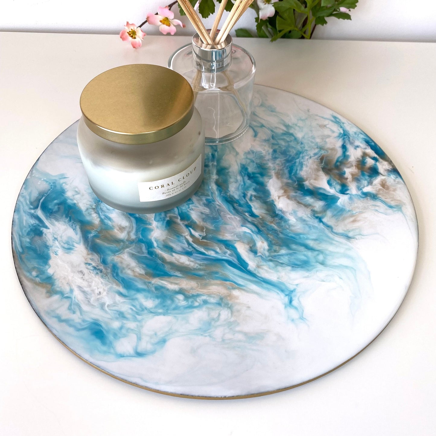 Handmade white and blue resin tray with slate base, large round coffee table and decorative tray, styled with candle and diffuser, plain display showing elegant resin design for home décor or serving.