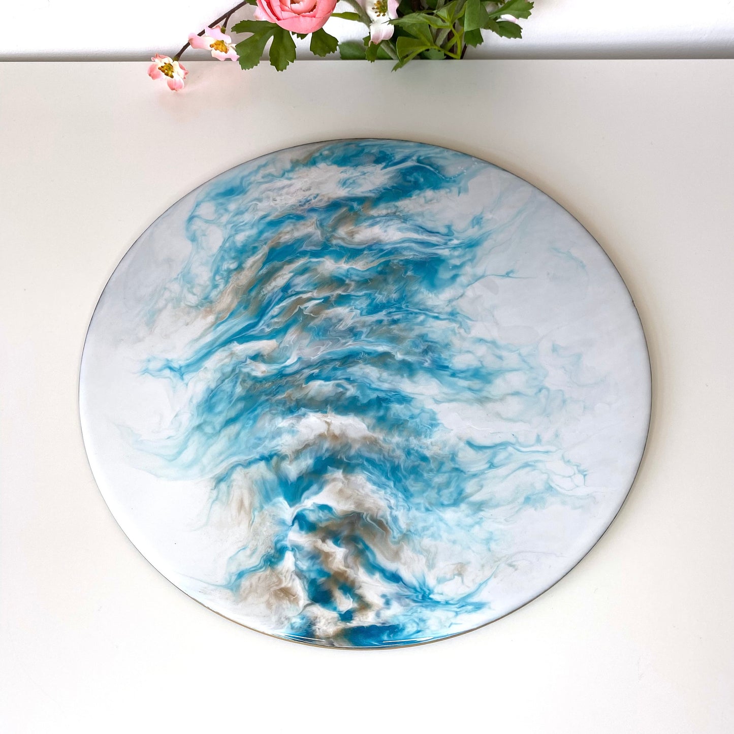 Top-down view of handmade white and blue resin tray with slate base, large round coffee table and decorative tray, empty display showing elegant resin design for home décor or serving.