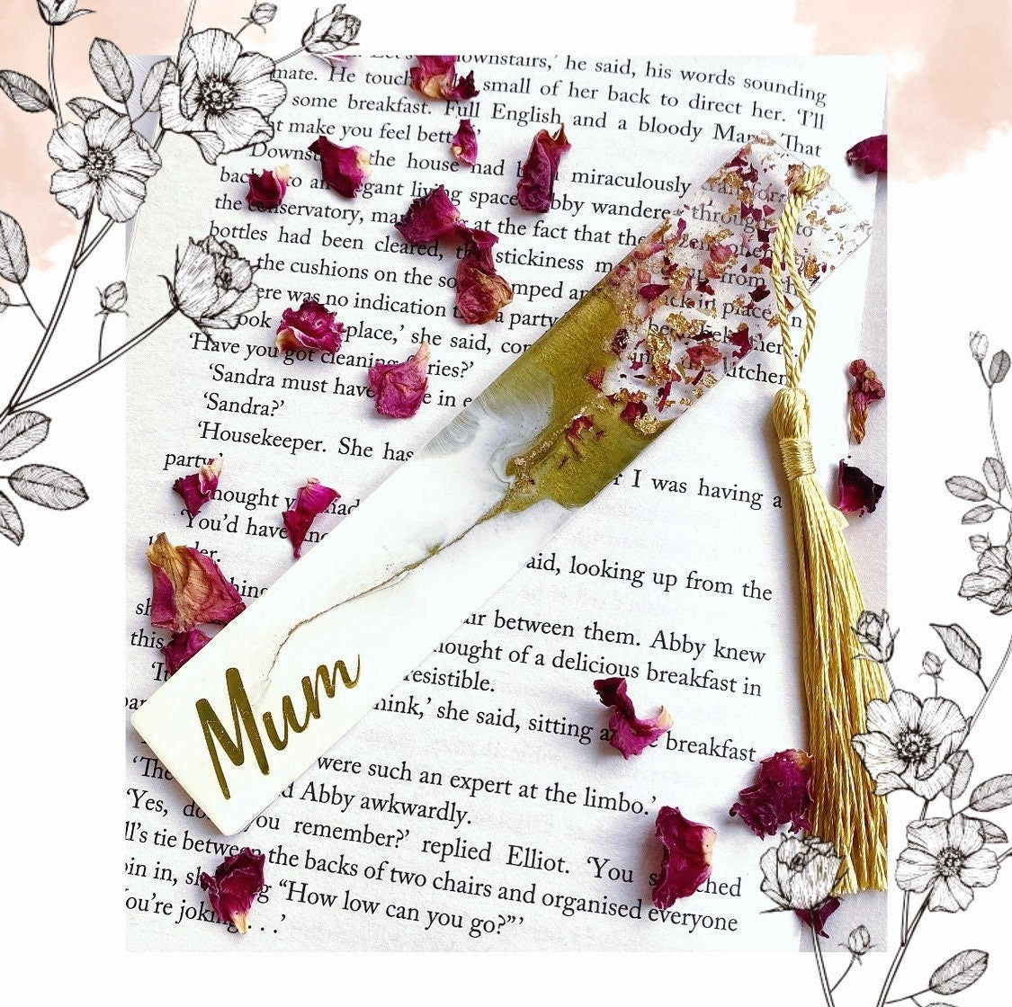Close-up of white and green resin bookmark with dried roses and gold leaf, personalised with gold vinyl, inside an open book, showing handmade details, ideal gift bookmark for readers.