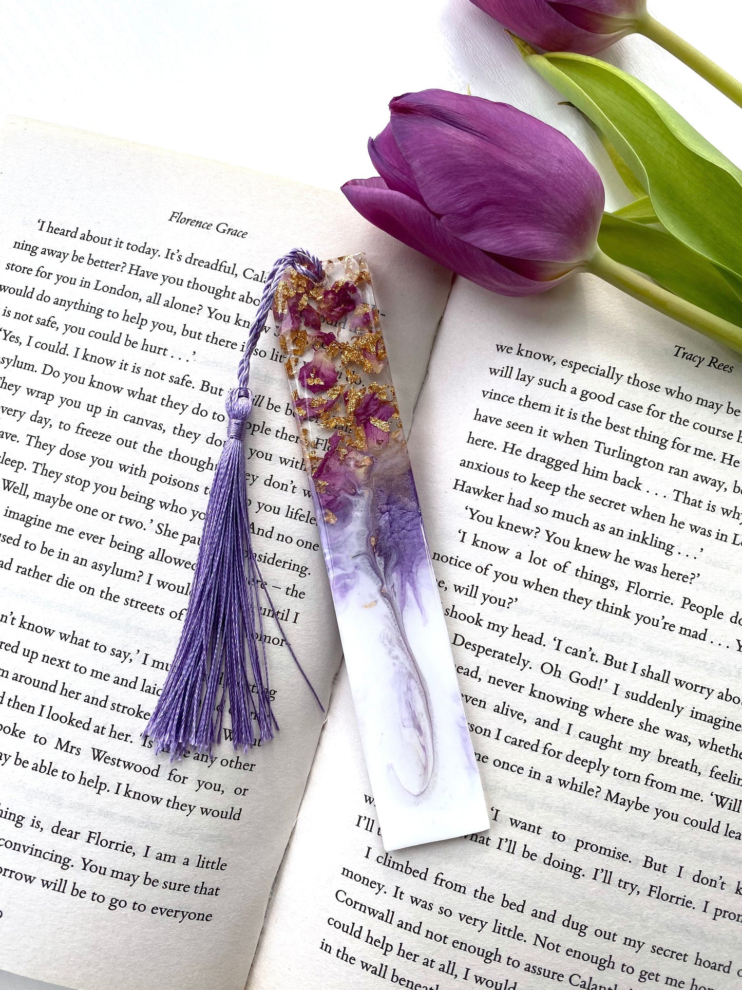 White resin bookmark with dried roses and gold leaf, non-personalised, placed inside an open book, handmade bookmark for readers or gifts
