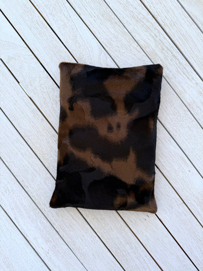 Back view of the handmade black and brown animal print velvet book sleeve, showing the plush fabric pattern without the button closure.