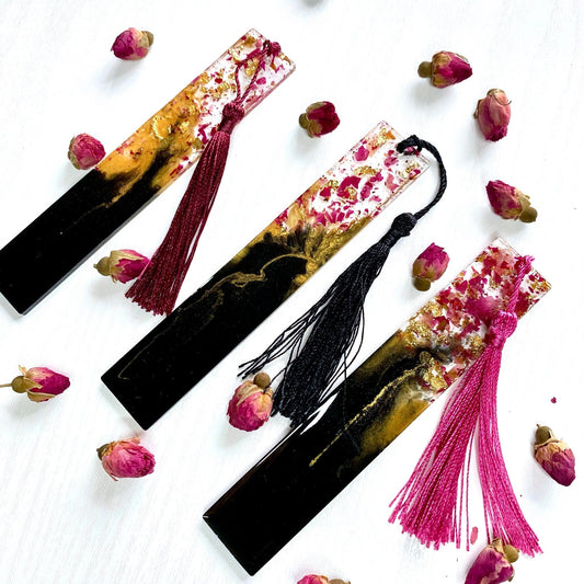 Black and gold resin bookmark with dried rose petals in clear resin top and matching colourful tassel attached