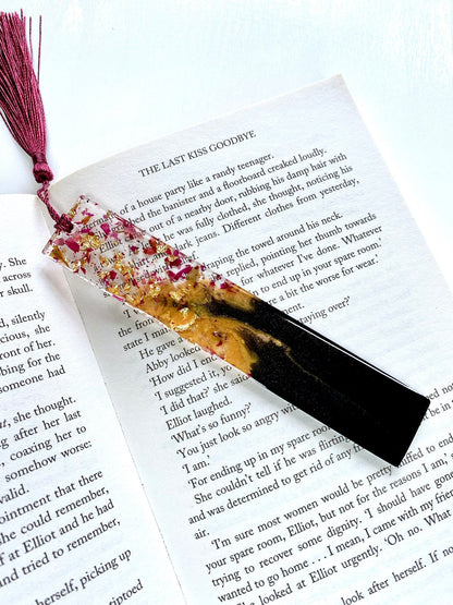 Decorative resin bookmark with floral elements shown on an open book