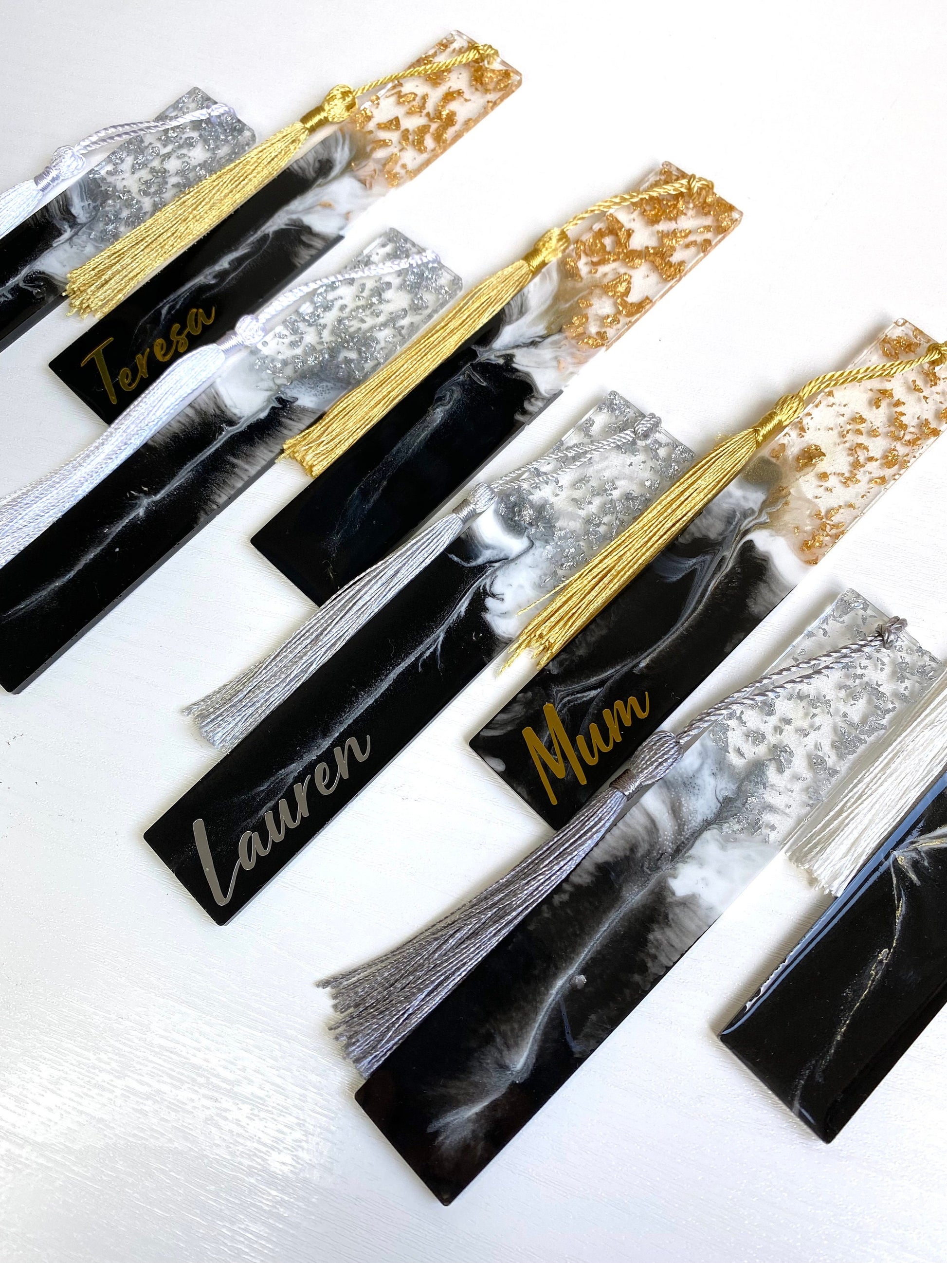 Close-up of eight black and white resin bookmarks with gold and silver leaf, including personalised and non-personalised options, showcasing handmade details, elegant bookmarks for readers or gifts