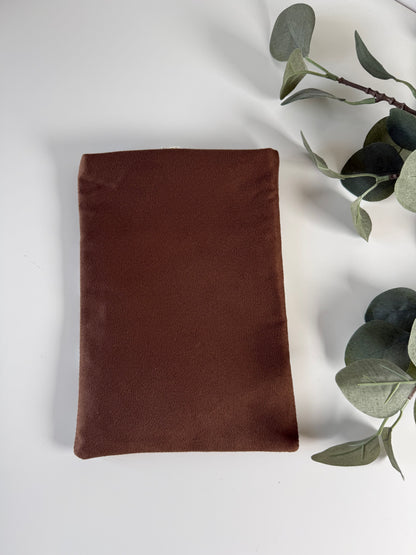 Back view of the handmade book sleeve showing its plain brown faux suede fabric without a floral pocket.