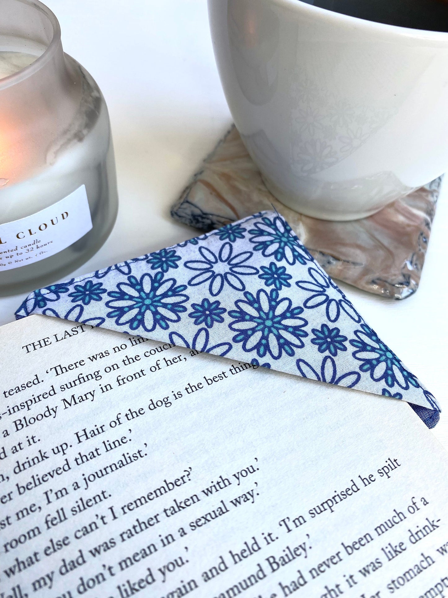 Handmade fabric corner bookmark in Daisy Print design, placed on a book page – perfect gift for book lovers, teachers, or readers.