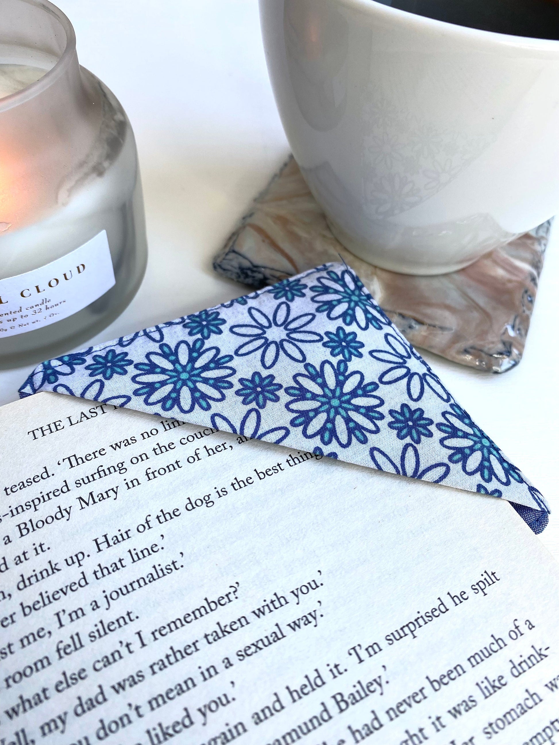 Handmade fabric corner bookmark in Daisy Print design, placed on a book page – perfect gift for book lovers, teachers, or readers.