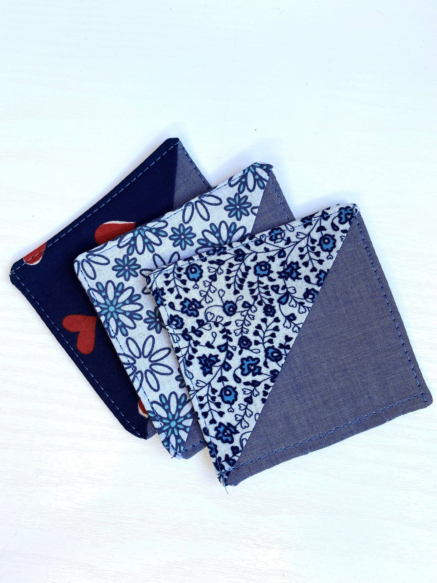 Three handmade fabric corner bookmarks in Heart Print, Tiny Flowers Print, and Daisy Print designs, displayed together – perfect gifts for book lovers and teachers.
