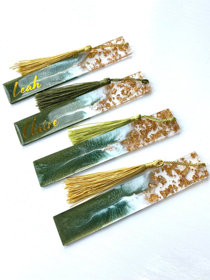 Four green resin bookmarks with gold leaf and colourful tassels, two personalised with gold vinyl and two non-personalised, handmade bookmarks for readers or gifts.