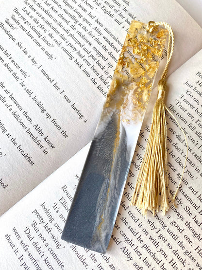 Grey and white resin bookmark with dried jasmine petals and gold leaf, non-personalised, featuring a gold tassel, elegant handmade bookmark for readers or gifts.