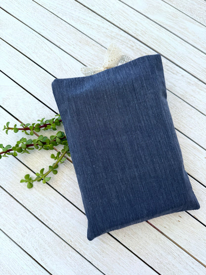Back view of a handmade navy denim-look fabric book sleeve, showing its plain navy reverse side and rectangular shape.