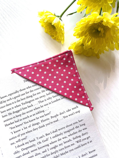 Personalised handmade fabric corner bookmark in Pink Polka Dots design with white dots, shown on a book page – perfect gift for book lovers, teachers, and readers.