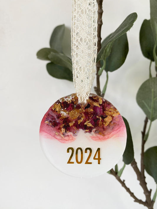 Personalised resin Christmas ornament with dried rose petals and gold leaf, hanging with 2025 year customisation, pink and white colours, lace ribbon included