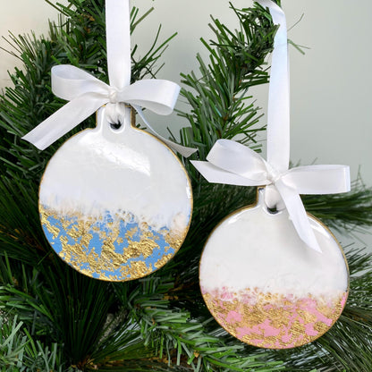 Pink and blue slate resin Christmas ornaments hanging on a Christmas tree, non-personalised, with gold leaf accents and white ribbons and bow
