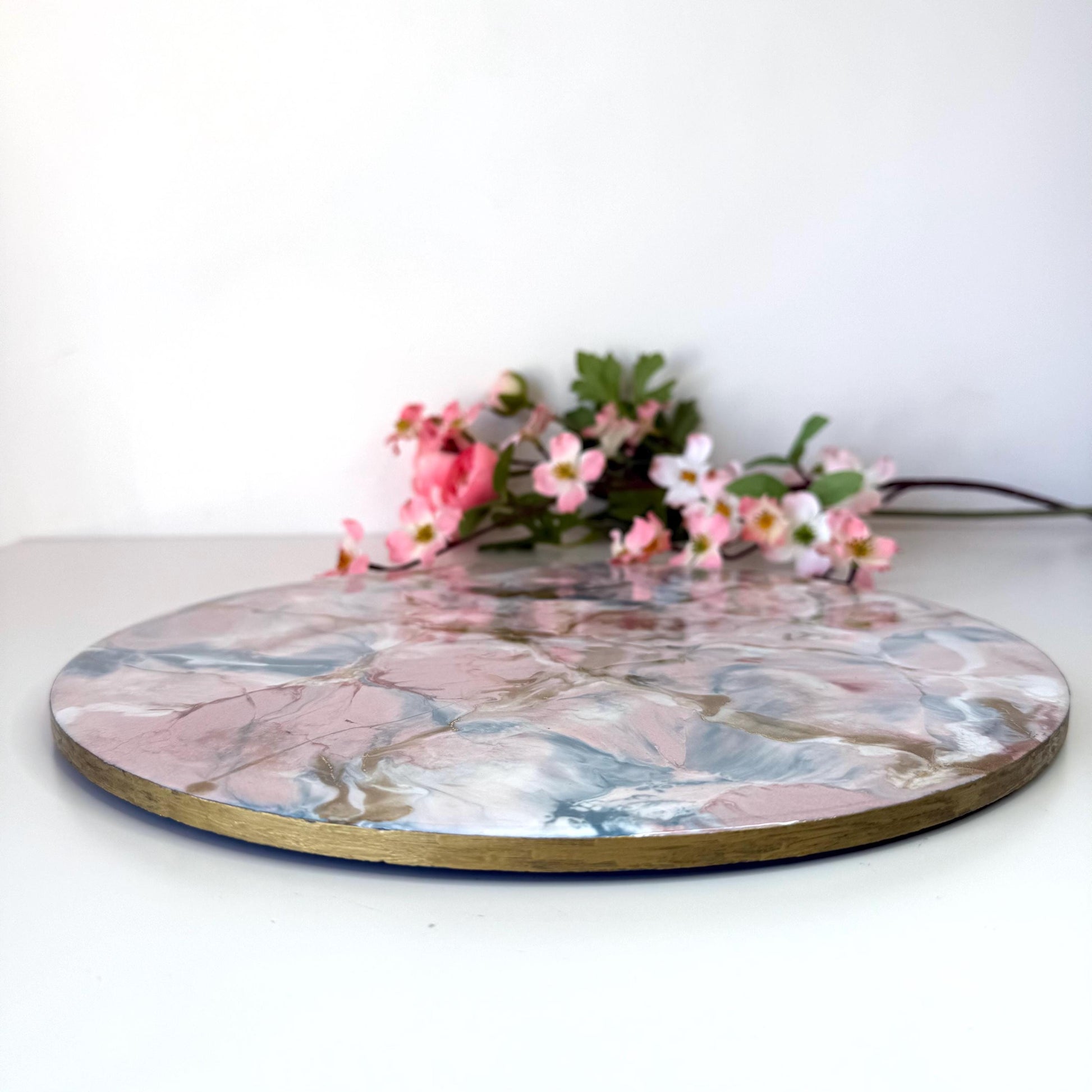 Pink and gold marble-style resin tray with slate base, showing height and hand-painted gold edges, round centrepiece, elegant handmade decorative tray for home or serving