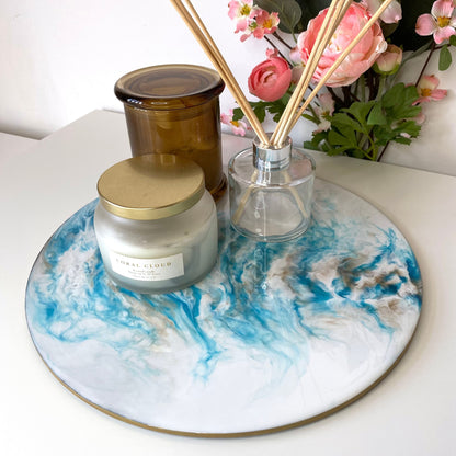 Handmade white and blue resin tray with slate base, large round coffee table and decorative tray, styled with candles and diffuser, elegant home display for serving or décor.