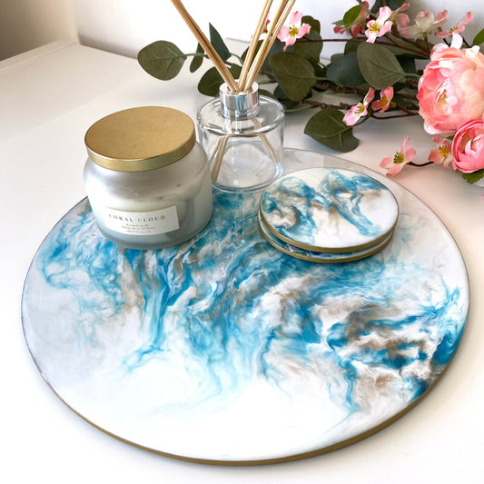 Handmade white and blue resin tray with slate base, large round coffee table and decorative tray, styled with candle, diffuser, and set of two matching resin coasters, elegant home display for serving or décor.